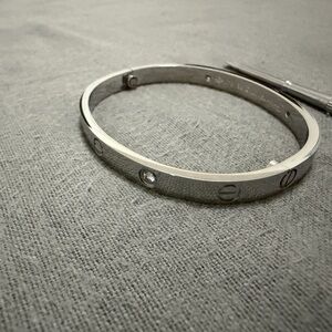 Silver-Tone Screw Motif Bangle with Clear Stone